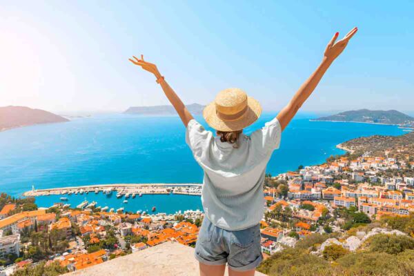 happy-woman-with-open-arms-stands-on-the-viewpoint